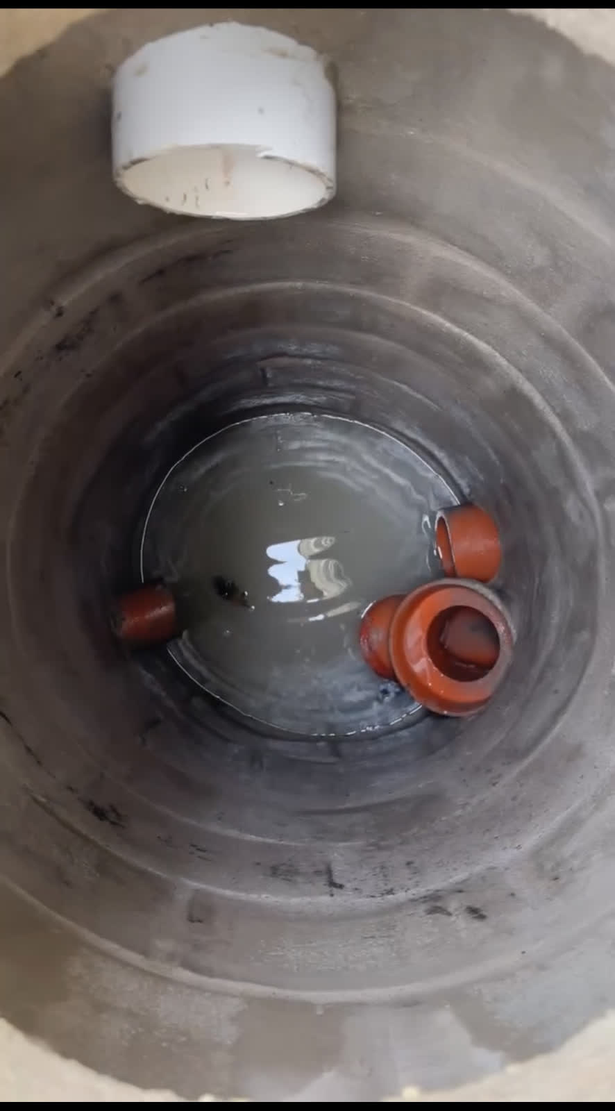 Inside a rebuilt Chicago catch basin — new clay inlets and PVC line set in fresh concrete