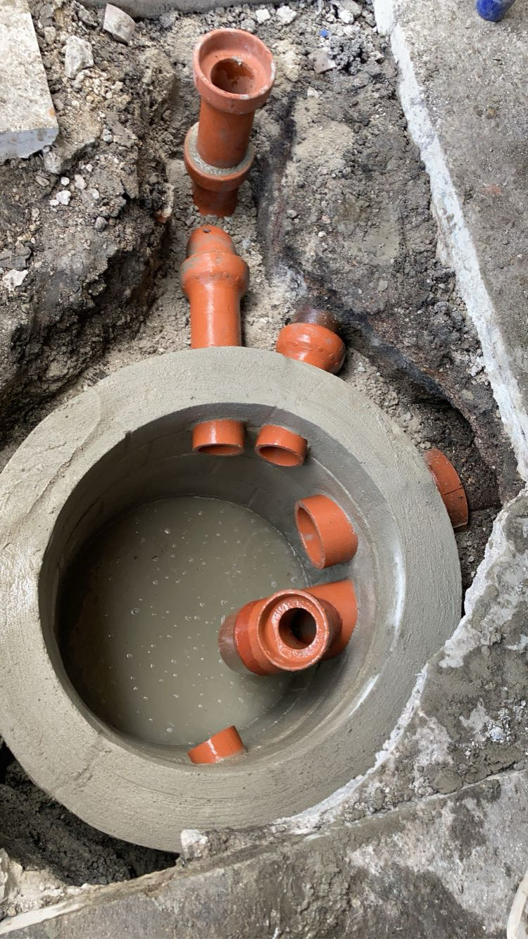 Rebuilt catch basin interior in Chicago with orange clay pipe inlets set in fresh mortar