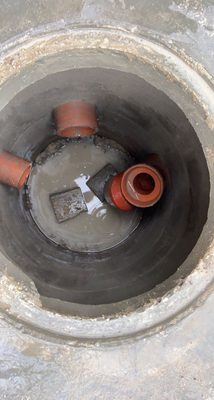 Fresh PVC sewer line replacement in an open trench on a Chicago job