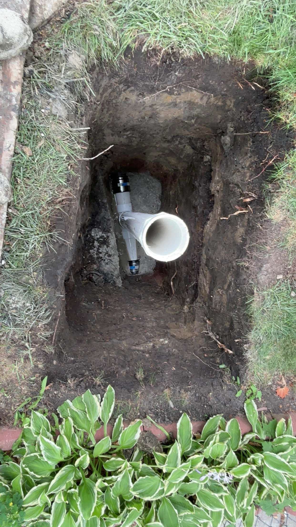 Chicago sewer cleanout yoke tied into the main line in a hand-dug pit