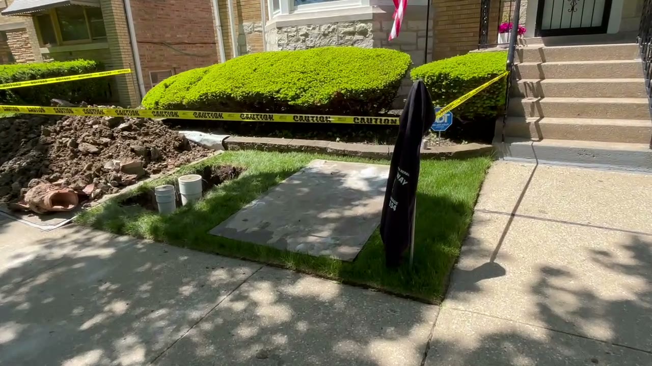 Chicago flood control install — Beverly front yard torn up mid-dig with caution tape and excavated brick