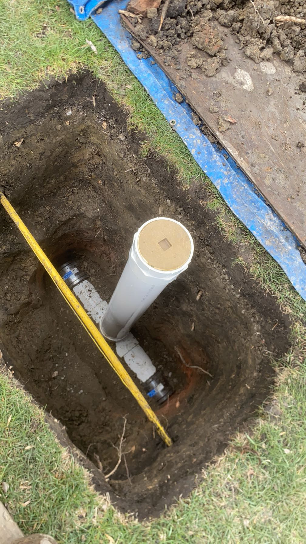 Chicago sewer cleanout replacement — new PVC cleanout capped and ready for backfill