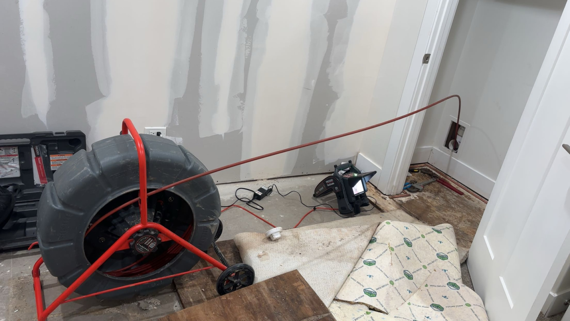 Sewer camera reel and monitor set up inside a Chicago home to inspect the line
